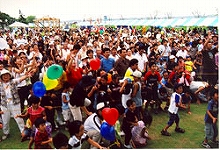 Participants trying to round up the lucky balls